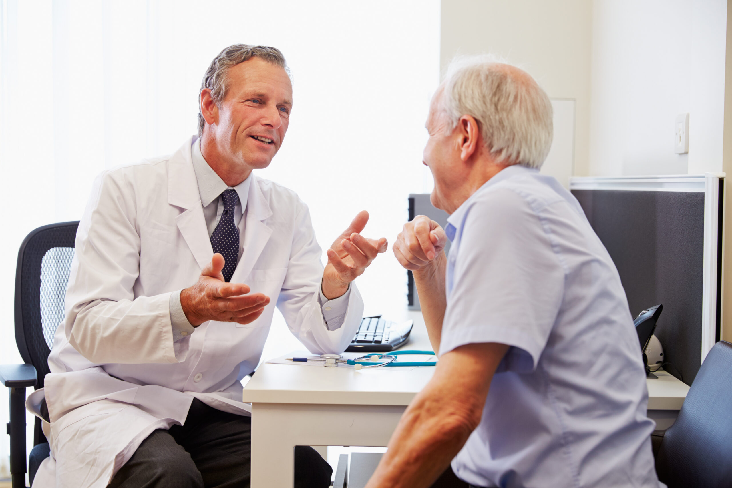 senior patient having consultation with doctor in office